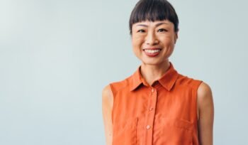 smiling-woman-orange-shirt