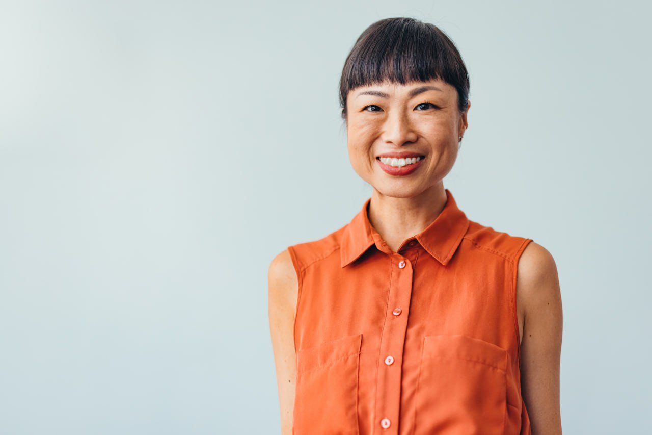 smiling-woman-orange-shirt